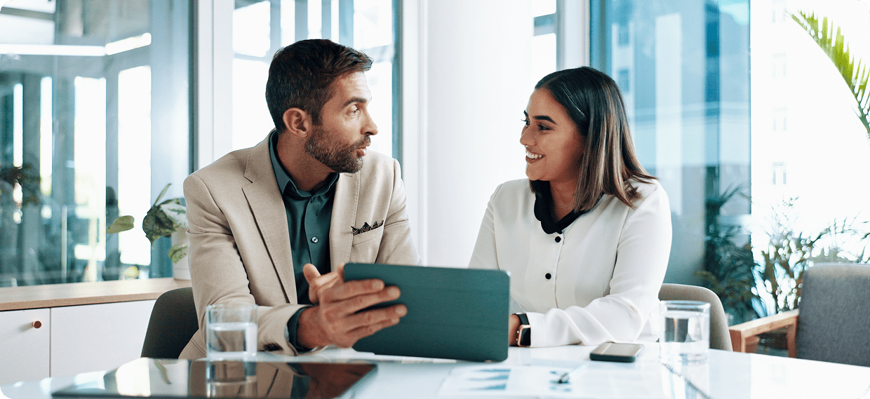 Two professionals discussing with a tablet.