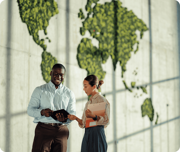 Two people discussing in front of map.
